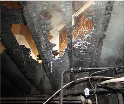 Photo 3. View from basement of floor area consumed by fire