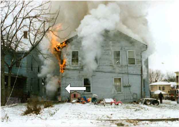 Photo 3.  Photograph of the rear of the burning structure, depicting the approximate origin of the fire. 