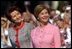 Mrs. Bush and Mrs. Kwasniewska stand together during the South Lawn ceremony at which the national anthems for both countries were performed and their husbands reviewed the troops.