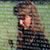 A woman's face reflected on the polished surface of the Vietnam Memorial