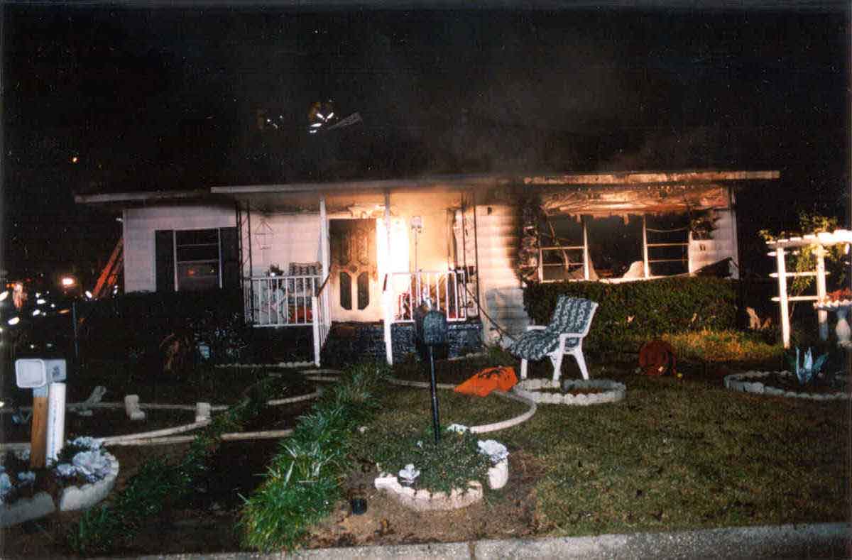 Incident Site, Single-Story Residential Home, Front of Structure, Right side of structure shows area of heavy fire involvement