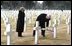 Vice President Dick Cheney places a rose on the grave of Wyoming solider Sgt. John Vannoy while touring the Sicily-Rome American Cemetery with his wife, Lynne, in Nettuno, Italy Jan. 26, 2004. The cemetery inters those who gave their life for the liberation of Italy during World War II. 