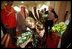 Two children greet Vice Present Dick Cheney and Mrs. Cheney with bouquets of flowers upon their arrival at Dasman Palace in Kuwait City, Kuwait, March 18. 