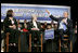 President George W. Bush talks with grandmother Margaret Valdez, center, and her granddaughter Jessica Valdez during a Conversation on Strengthening Social Security in Albuquerque, N.M., Tuesday, March 23, 2005.