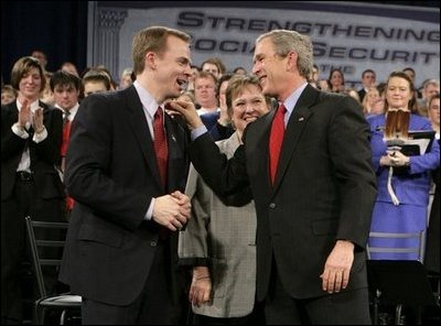 President George W. Bush shares a laugh with Dr. Jeffery Brown, Assistant Professor of the Finance Department at the University of Illinois at Urbana-Champaign, during a discussion on Social Security reform in Fargo, N.D., Thursday, Feb. 3, 2005. Also pictured, center, is conversation participant Mary Bond, a retired worker.