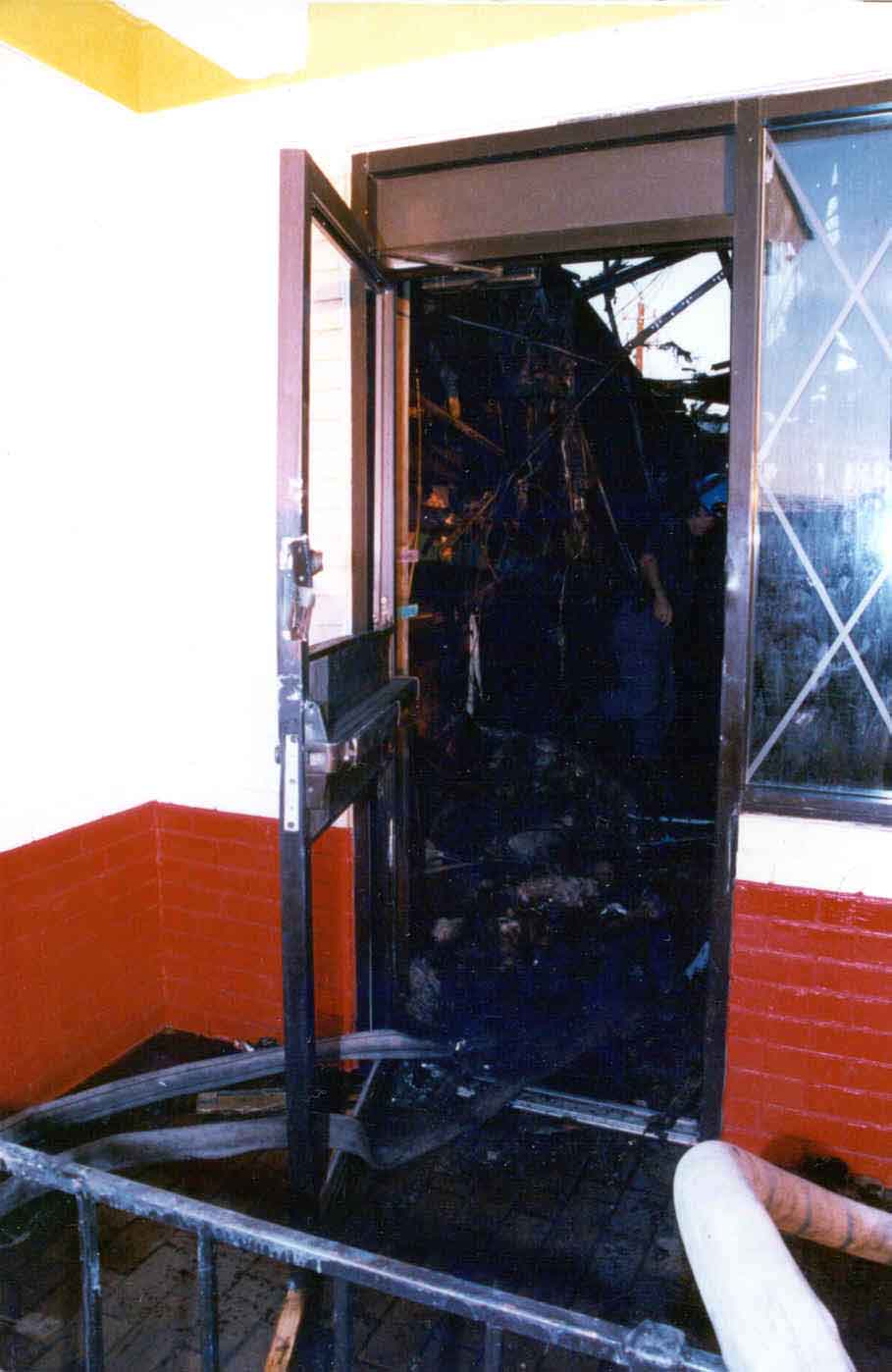 Photo 6: Post-fire, exterior view of the west side door of the restaurant.