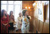 Mrs. Laura Bush looks over a photographic exhibit during a luncheon in Mar del Plata Saturday, Nov. 5, 2005, hosted by Argentine First Lady Mrs. Cristina Fernandez de Kirchner, far left. 