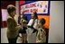 Hainerberg elementary students Montana Feix and Matt Bowlsby greet Laura Bush as she arrives to the school Tuesday, Feb. 22, 2005, in Wiesbaden, Germany. During her visit to the school Mrs. Bush heard a recital by the school chorus and talked with a group of fourth and fifth graders. 