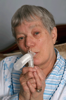 photo of an older woman using a nebulizer.