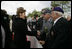 First Lady Laura Bush shakes hands with a veteran following a ceremony Sunday, May 8, 2005, in Margraten, Netherlands honoring those who served in World War II. The ceremony highlighted the President and First Lady’s visit to the Netherlands before moving on to Moscow.