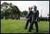 President George W. Bush walks with India's Prime Minister Dr. Manmohan Singh, Monday, July 18, 2005, on the South Lawn of the White House, during Singh's official arrival ceremony. 