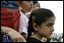 A young girl waits for the official arrival of India's Prime Minister Dr. Manmohan Singh, holds an American and India flag, Monday, July 18, 2005, on the South Lawn of the White House. 