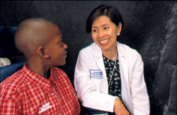 A doctor smiling at a young boy