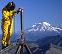 Researcher welding a GPS station on the flanks of Mount St. Helens
