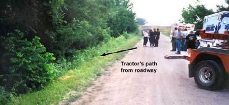 Photo 3 - Incident scene facing east, showing road conditions and path the tractor traveled into the ditch.