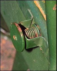 Close-up of spring-loaded pin on left side
