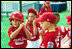 Suited up in red, the Cherry Point Marine Corps Air Station Devil Dogs prepare for their turn at bat during a game against the Bolling Air Force Base Little League Cardinals June 13, 2004. The Devil Dogs hail from Havelock, N.C., and the Cardinals are from Washington, D.C.