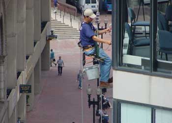 Figure 3. Window washer using rope descent system with a seat board