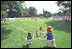 President George W. Bush attends a Tee Ball on the South Lawn game between the Cardinals and the South Berkeley Little League Braves from Inwood, West Virginia. June 23, 2002.