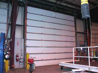 Photo 1. The overhead door that was involved in the fatal incident: a standard lift steel insulated door with six-inch lift drums.