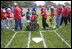 President George W. Bush hosts a White House Tee Ball (t-ball) game on the South Lawn between the Waynesboro, Virginia Little League Challenger Division Sand Gnats (Blue Team) vs. the East Brunswick, New Jersey Babe Ruth Buddy Ball League Sluggers (Red Team) September 22, 2002.