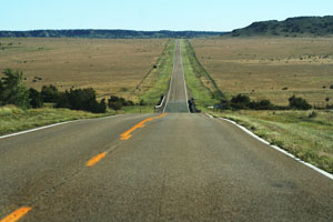 Rural highway disappearing into the horizon. If you need further assistance, call 800-853-1351 or email answers@bts.gov.