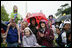 Guests brave a steady rain on the South Lawn of the White House during the 2006 White House Easter Egg Roll, Monday, April 17, 2006.