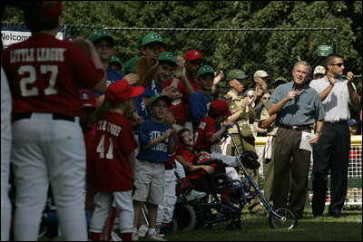 President George W. Bush welcomes players and their family members from the West University Little League Challengers from Houston, Texas, and the District 12 Little League Challengers from Williamsport, Pa., Sunday, July 24, 2005, at a Tee Ball game on the South Lawn of the White House.