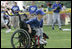 A young ballplayer from the District 12 Little League Challengers  of Williamsport, Pa., works the outfield Sunday, July 24, 2005, at a Tee Ball game on the South Lawn of the White House.