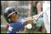 Shaquana Smith of the Jackie Robinson South Ward Little League Black Yankees of Newark, N.J., swings at the ball Sunday, June 26, 2005, during "Tee Ball on the South Lawn."