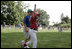 A player from the West University Little League Challengers from Houston, Texas cheers after scoring a run during a game on the South Lawn of the White House on Sunday July 24, 2005.