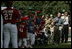 President George W. Bush welcomes players and their family members from the West University Little League Challengers from Houston, Texas, and the District 12 Little League Challengers from Williamsport, Pa., Sunday, July 24, 2005, at a Tee Ball game on the South Lawn of the White House.