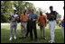 President George W. Bush laughs with Major League Baseball Hall of Fame players Ozzie Smith and Paul Molitor and former umpire Steve Palermo while congratulating Challenger Tee Ball players after a game on the South Lawn of the White House on Sunday July 24, 2005.