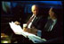 Vice President Dick Cheney holds a pre-dawn briefing in his car outside the Dwight D. Eisenhower Executive Office Building Jan 23, 2002.