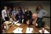 Immediately after the Sept. 11 terrorist attacks, Vice President Dick Cheney and senior staff gathered in the Presidential Emergency Operations Center. White House staff collected and discussed information as the day unfolded, and they kept in contact with the President. Photographed are Counselor Karen Hughes (seated left), National Security Advisor Dr. Condoleezza Rice (seated right), Deputy Chief of Staff Josh Bolten (far left), Director of Media Affairs Tucker Eskew, Assistant to the President Nick Calio, Counselor to the Vice President Mary Matalin, Chief of Staff for the Vice President Lewis Libby, and Director of the National Economic Council Larry Lindsey (right).