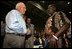 Vice President Dick Cheney visits with families who have been relocated from their homes in Louisiana and Mississippi to the Austin Convention Center in Austin, Texas Saturday, September 10, 2005. The Convention Center has been designated as one of the many temporary shelters for Katrina Hurricane evacuees. 