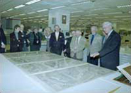 John Hébert, chief of the Geography and Map Division, discusses the Waldseemüller map in the Conservation laboratory during a March 2002 meeting of the Phillips Society, a private sector support group for the division. From left: Diane Nester Kresh, director of Public Service Collections; Ralph Ehrenberg, former chief of the division; Dorothy Denchy and Sharon Schurtter of the Library staff; Thomas Touchton, Alice Hudson, Eric Wolf, Richard Stephenson, and Robert Highbarger (partially hidden).