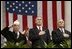 President George W. Bush stands with National Commander of the Army and Navy Union David Berger, left, and Secretary of Veterans Affairs Anthony Principi during the Veterans Day ceremonies at Arlington National Cemetery Tuesday, Nov. 11, 2003. "We observe Veterans Day on an anniversary -- not of a great battle or of the beginning of a war, but of a day when war ended and our nation was again at peace," said the President. "Ever since the Armistice of November the 11th, 1918, this has been a day to remember our debt to all who have worn the uniform of the United States."