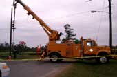 A boom truck with an auger attached.