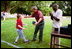 President George W. Bush hosts Tee Ball on the South Lawn with The Oriole Advocates Challengers of Marley Area Little League of Glen Burnie, Maryland and The Ridley Police Challengers of Leedom Little League, Ridley Park, Pennsylvania, July 27, 2003.