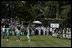 President George W. Bush stands for the singing of the national anthem with representatives of the All-American Girls Professional Baseball League Players Association during the opening ceremony for the last game of the 2003 White House South Lawn Tee Ball season Sunday, Sept. 7, 2003. The AAGPBL gave more than 600 woman the opportunity to play professional baseball from 1943 to 1954.