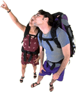 A photograph of a man and woman carrying backpacks, looking skyward.