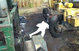 Photo 3 – View between the forklift and the hydraulic power unit, facing north, showing position of the victim after he fell to the ground.