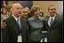 Laura Bush poses for photos with Homeboy Industries representatives, Gustavo Mojica, Herbert Corleto and Gabriel Hinojos, Thursday, Oct. 27, 2005 at Howard University in Washington, at the White House Conference on Helping America's Youth. 