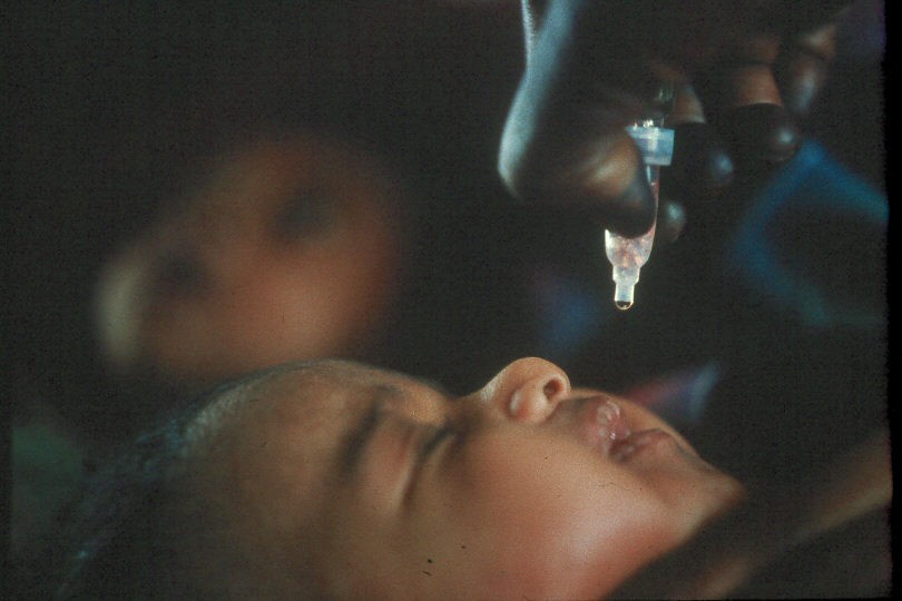 baby receiving oral polio vaccine