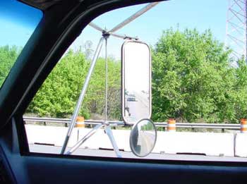 Mirrors mounted on each door of the dump truck.