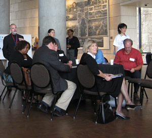 Seated participants listen to speakers.