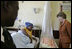 Laura Bush visits with a mother and her newborn baby while meeting with the group, "Mothers to Mothers-to-Be," in Cape Town, South Africa, Tuesday, July 12, 2005. The program provides support to HIV-positive women during their pregnancy. 