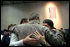 President Bush consoles a family during his trip to New York Sept. 14. 