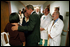 President Bush and Mrs. Laura Bush comfort family members at Washington Hospital Center Sept. 13. The President and First Lady visited the hospital to thank doctors and visit patients wounded in the attack on the Pentagon.